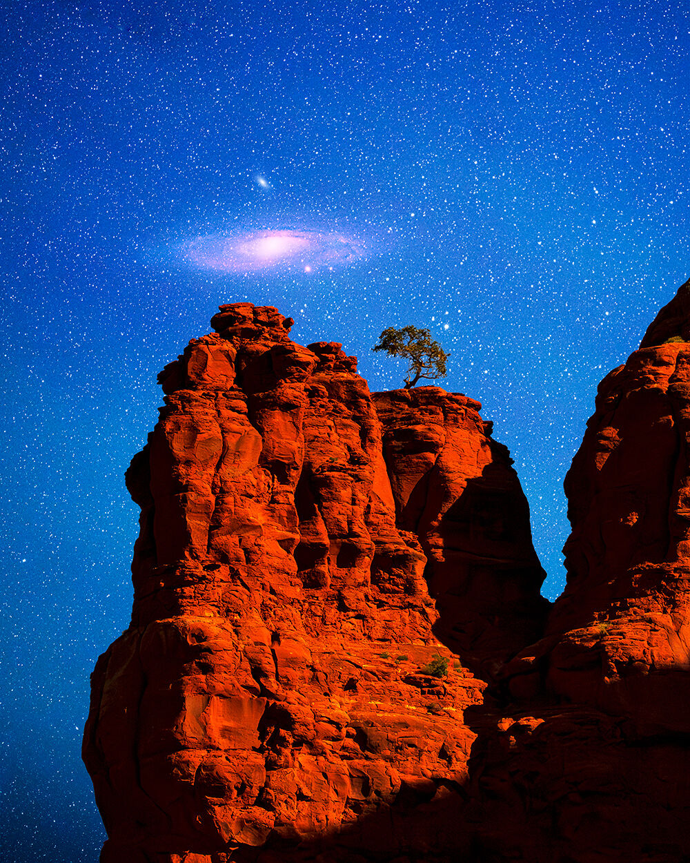 The Andromeda galaxy rising above Bell Rock in Sedona.