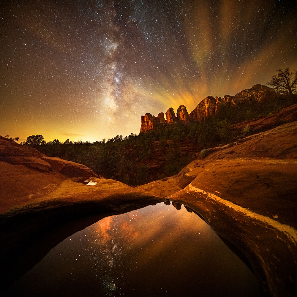 Seven Sacred Pools with the Milky Way and streaking clouds in a long exposure.