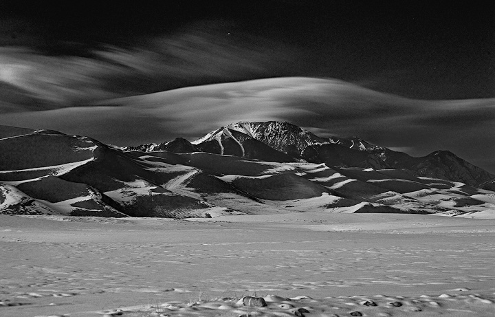 High winds cause a wave cloud to form over Mount Herard in winter. This was taken about 30 minutes after sunset; a few stars...